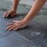 Worker installing ceramic floor tiles